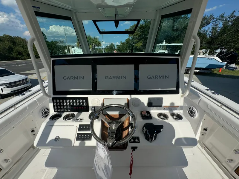 Slide: The Image of 2025 Caymas 401 CC boat helm with Garmin navigation displays and modern controls. - 35