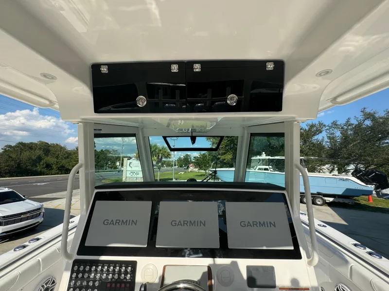 Slide: The Image of 2025 Caymas 401 CC boat dashboard with Garmin navigation displays. - 36