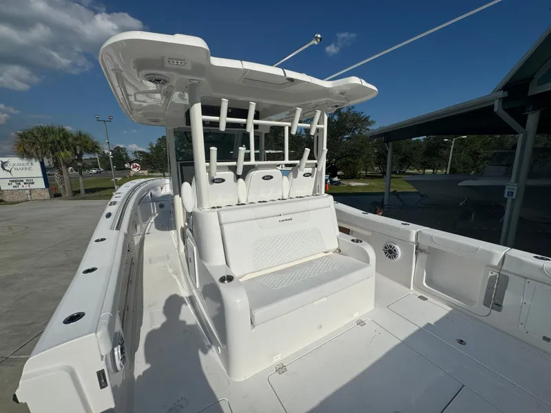 Slide: The Image of 2025 Caymas 401 CC boat with spacious deck and seating under clear blue sky. - 37