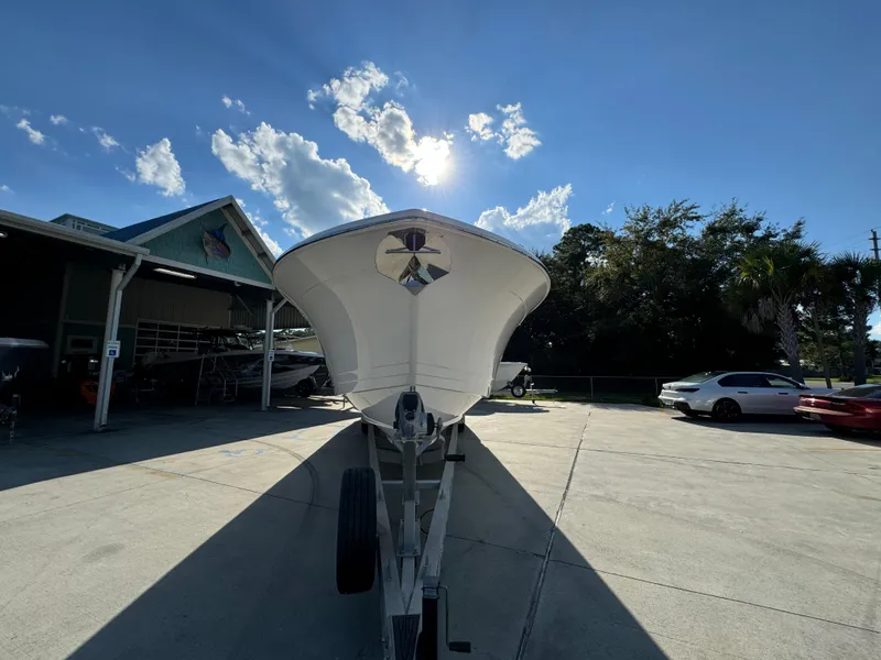 Slide: The Image of 2025 Caymas 401 CC boat on trailer under sunny sky. - 8