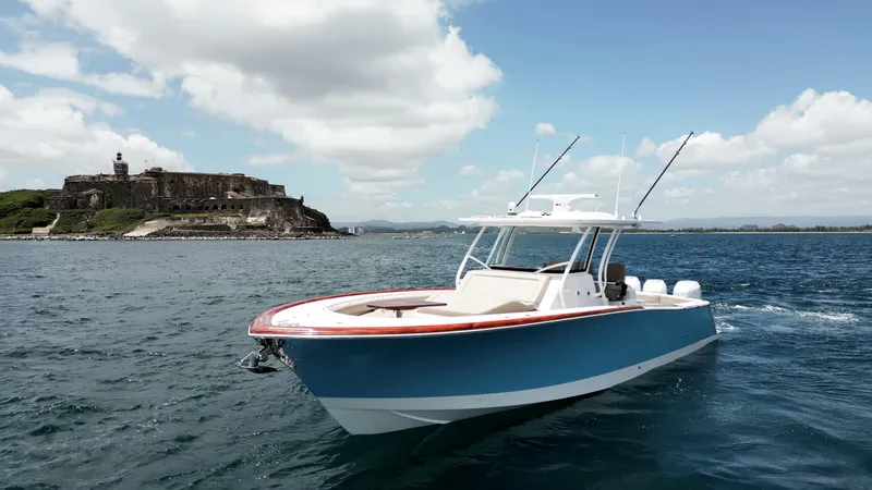 The Image of 2025 Vicem CC boat cruising near a historic coastal fort under a partly cloudy sky. - 1