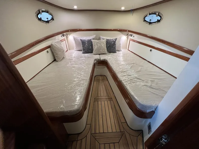 Slide: The Image of Luxurious 2025 Vicem CC yacht cabin with elegant wood accents and plush bedding. - 5