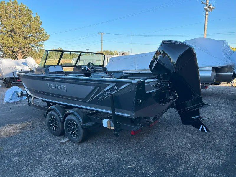 Slide: The Image of 2025 Lund 2075 Impact XS fishing boat with outboard motor on trailer. - 1