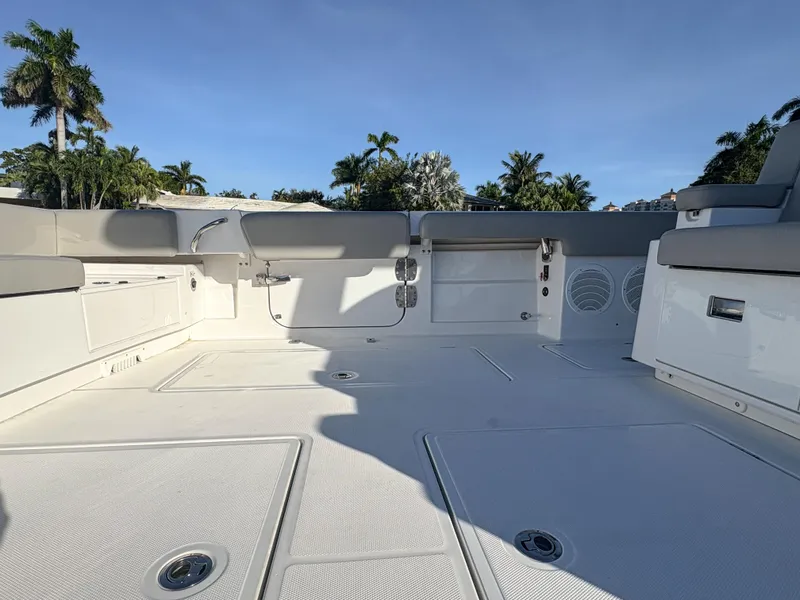 Slide: The Image of Spacious deck of 2023 HCB 53 Sueños boat under clear blue sky. - 16