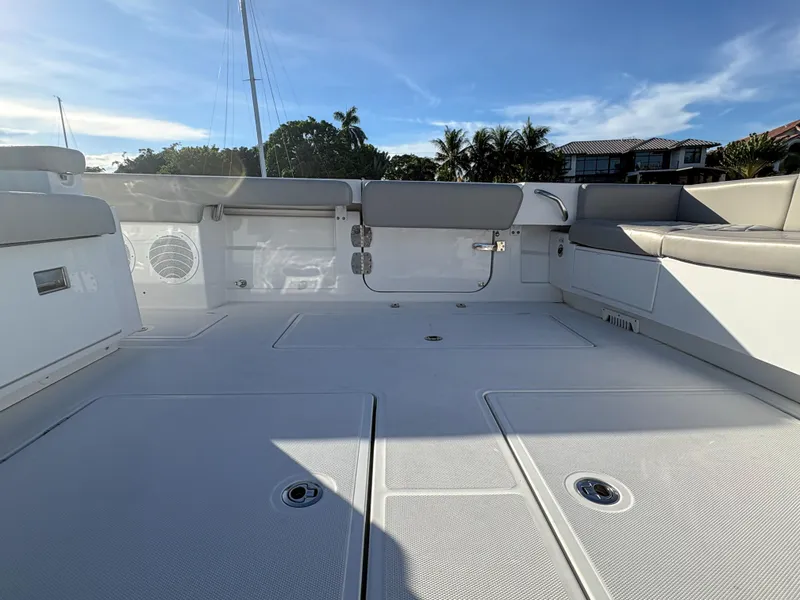 Slide: The Image of Spacious deck of 2023 HCB 53 Sueños boat under clear blue sky. - 17