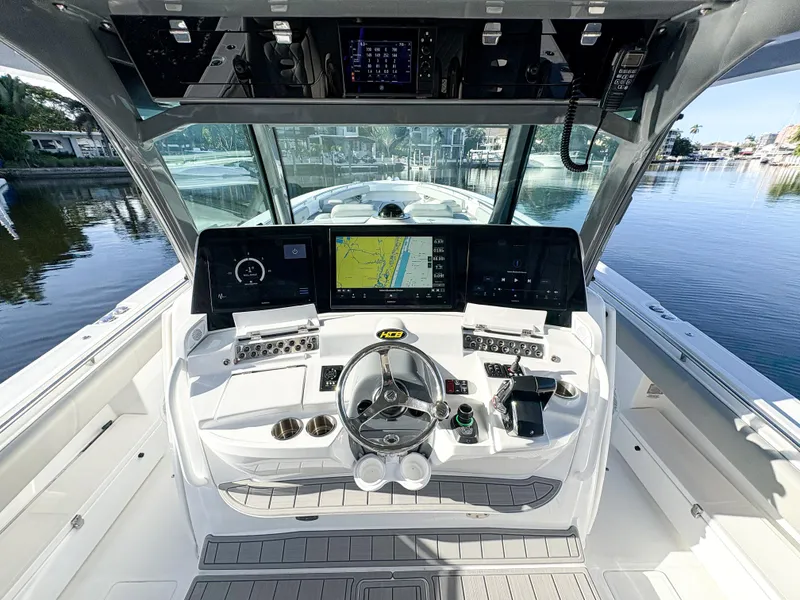 Slide: The Image of 2023 HCB 53 Sueños boat cockpit with advanced navigation system and steering wheel. - 20