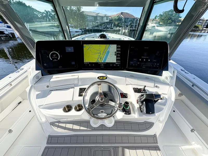Slide: The Image of 2023 HCB 53 Sueños boat helm with advanced navigation system and sleek design. - 21