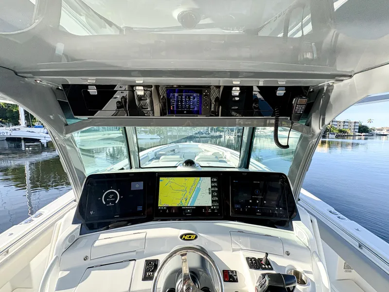 Slide: The Image of 2023 HCB 53 Sueños boat dashboard with advanced navigation system and controls. - 22