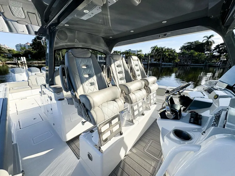 Slide: The Image of Luxury interior of 2023 HCB 53 Sueños boat with plush seating and modern controls. - 23