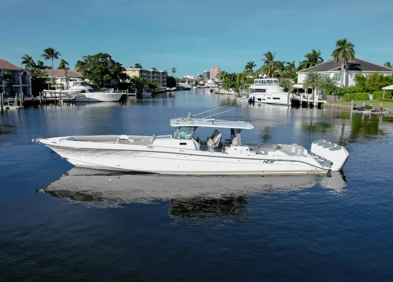 Slide: The Image of 2023 HCB 53 Sueños luxury boat on a serene waterway. - 3