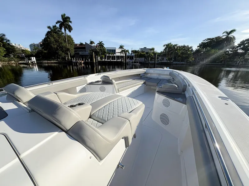 Slide: The Image of 2023 HCB 53 Sueños luxury boat with spacious seating on calm water. - 32