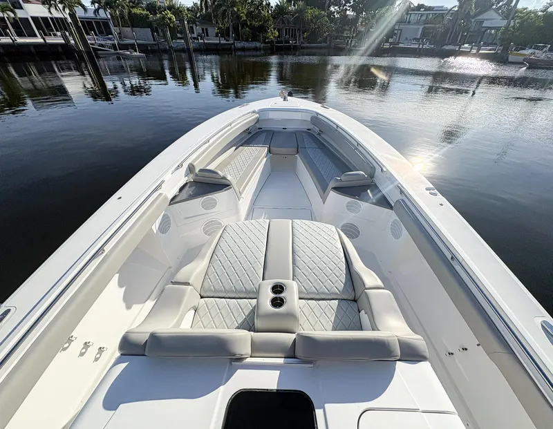 Slide: The Image of 2023 HCB 53 Sueños luxury boat with spacious seating on calm water. - 33