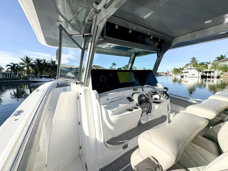 Slide: The Image of 2023 HCB 53 Sueños boat interior with modern helm and luxurious seating. - 35