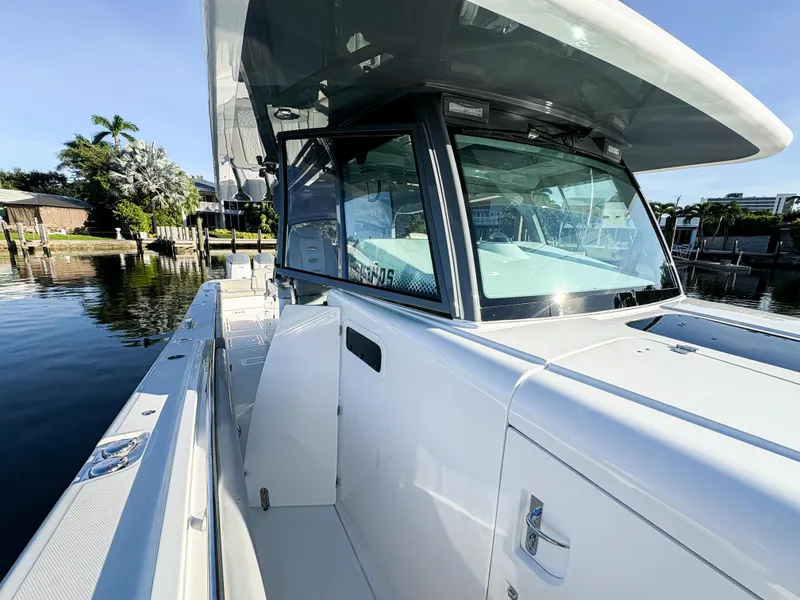 Slide: The Image of 2023 HCB 53 Sueños luxury boat docked by the water. - 36