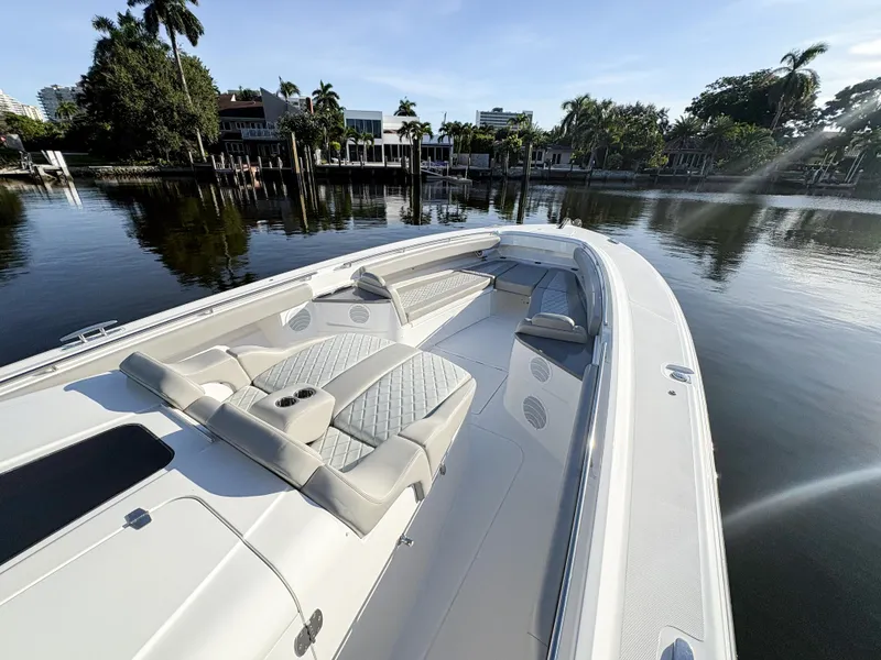 Slide: The Image of 2023 HCB 53 Sueños luxury boat on calm water, featuring spacious seating and elegant design. - 37