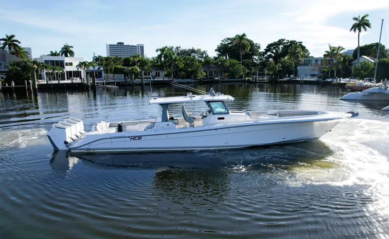 Slide: The Image of 2023 HCB 53 Sueños boat cruising in a scenic waterfront setting. - 4