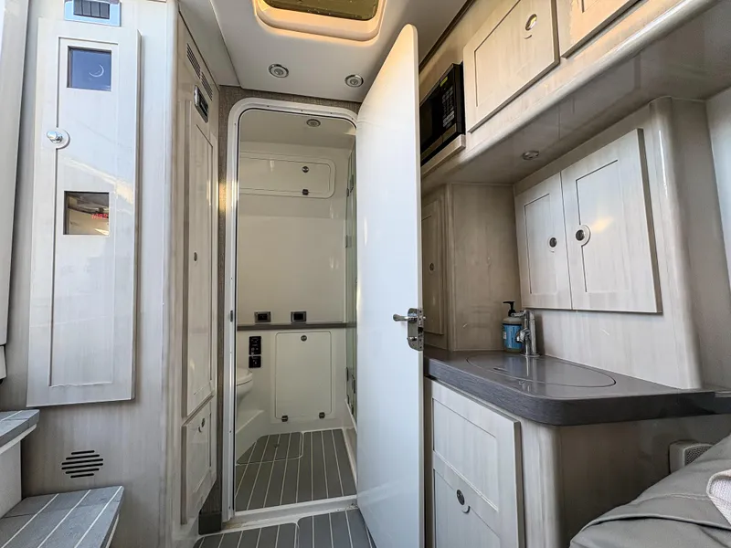 Slide: The Image of Interior of 2023 HCB 53 Sueños boat, featuring modern cabinetry and sleek design. - 46