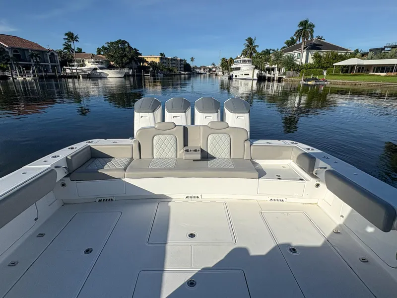 Slide: The Image of 2023 HCB 53 Sueños boat on a calm waterfront, featuring spacious seating. - 6