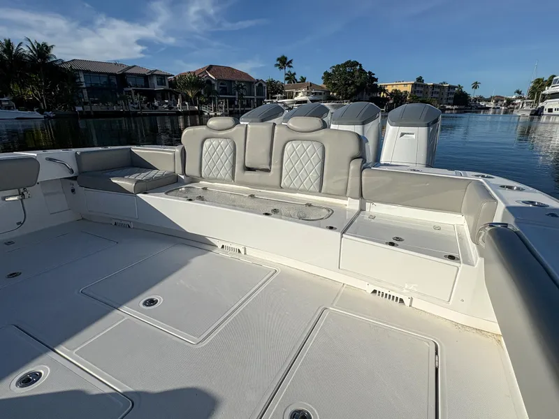 Slide: The Image of 2023 HCB 53 Sueños luxury boat interior with cushioned seating and waterfront view. - 9
