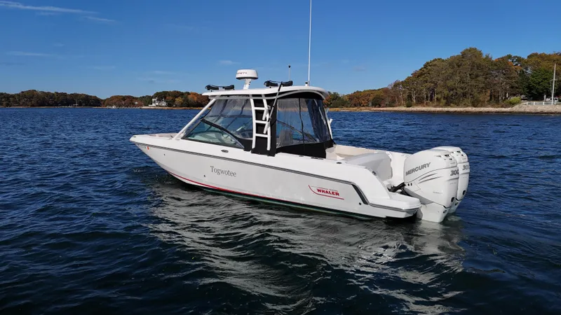 Slide: The Image of 2018 Boston Whaler 270 Vantage boat on calm water, clear sky, scenic background. - 2