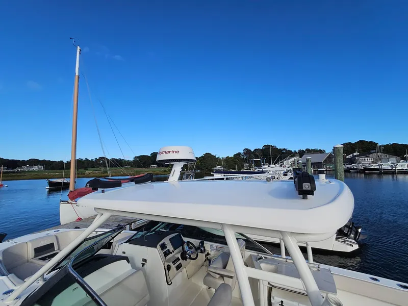 Slide: The Image of 2018 Boston Whaler 270 Vantage boat docked in a serene marina. - 24