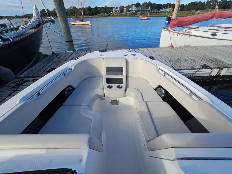 Slide: The Image of 2018 Boston Whaler 270 Vantage boat interior at dock, featuring spacious seating and scenic waterfront. - 4