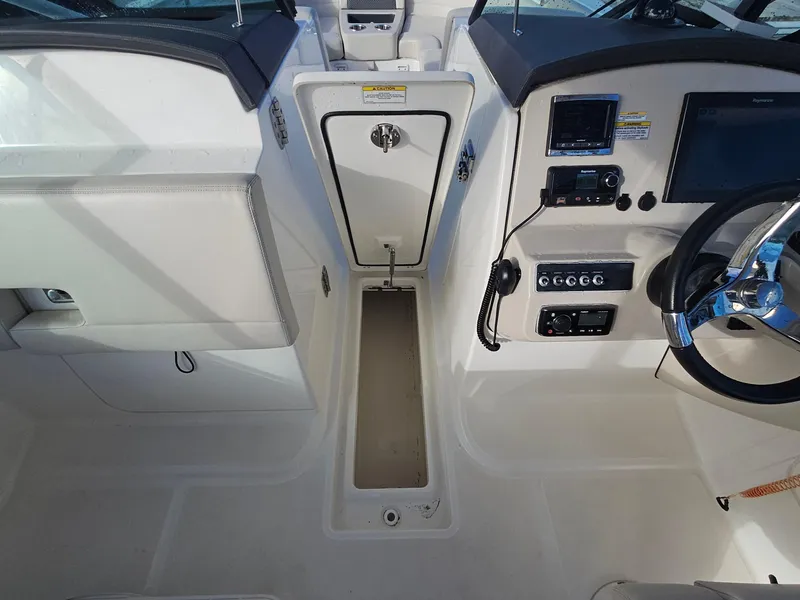 Slide: The Image of 2018 Boston Whaler 270 Vantage boat cockpit with steering wheel and control panel. - 8