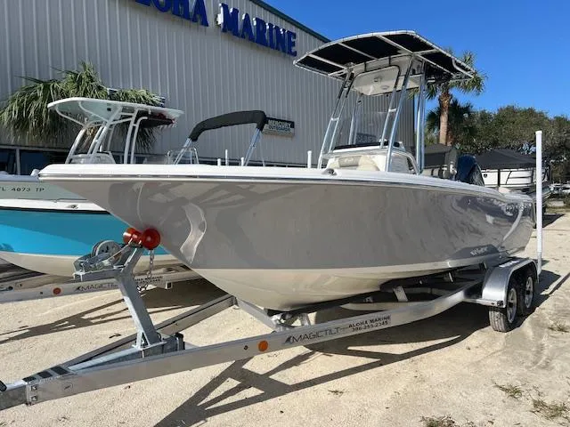 Slide: The Image of 2025 Key West 203 FS boat on trailer outside marine store. - 1