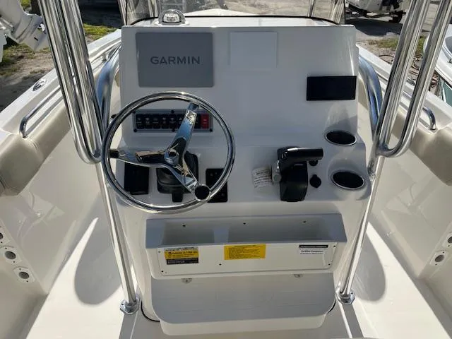 Slide: The Image of Key West 203 FS 2025 boat console with Garmin navigation system and steering wheel. - 5