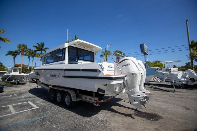 Slide: The Image of 2025 Quarken 35 Cabin boat on trailer with Yamaha engines, parked outdoors. - 10