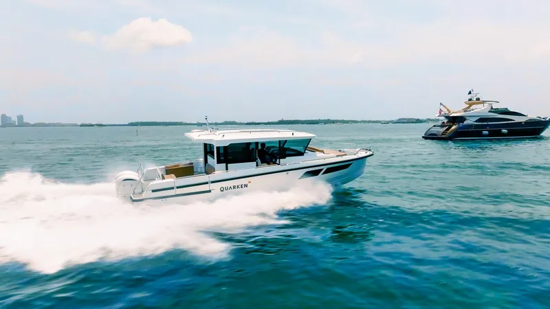 Slide: The Image of 2025 Quarken 35 Cabin boat cruising on open water, with another yacht in the background. - 4