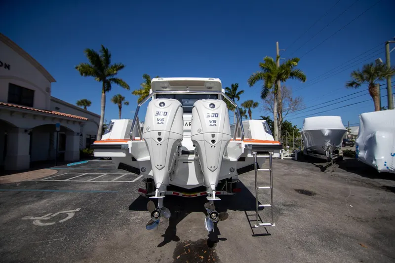 Slide: The Image of 2025 Quarken 35 Cabin boat with dual 300 V6 engines, parked outdoors under clear blue sky. - 9