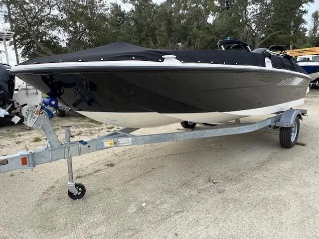 Slide: The Image of 2025 Bayliner Element E18 boat on trailer, covered and parked outdoors. - 0