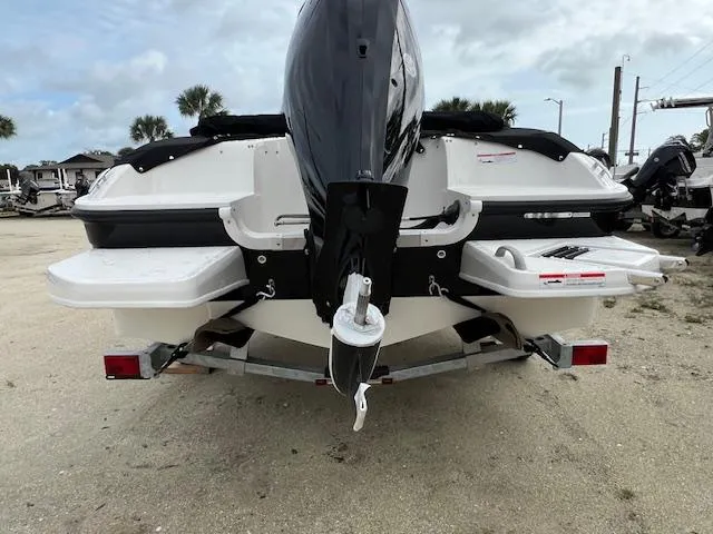 Slide: The Image of 2025 Bayliner Element E18 boat rear view with outboard motor on trailer. - 1