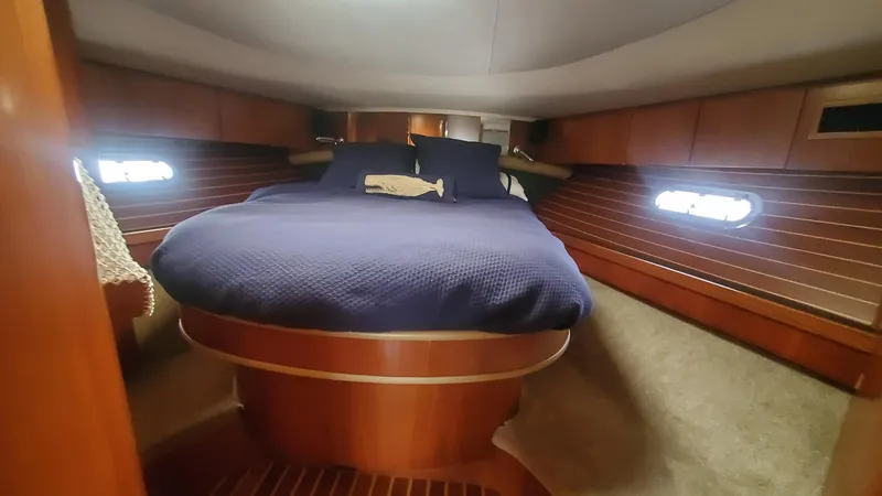 Slide: The Image of Luxurious cabin interior of 2001 Tiara Yachts 52 Express Cruiser with cozy bedding. - 14