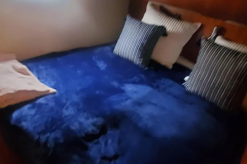 Slide: The Image of Cozy bedroom with blue bedding in 2001 Tiara Yachts 52 Express Cruiser. - 16