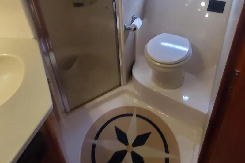 Slide: The Image of Bathroom of 2001 Tiara Yachts 52 Express Cruiser with shower and toilet. - 17
