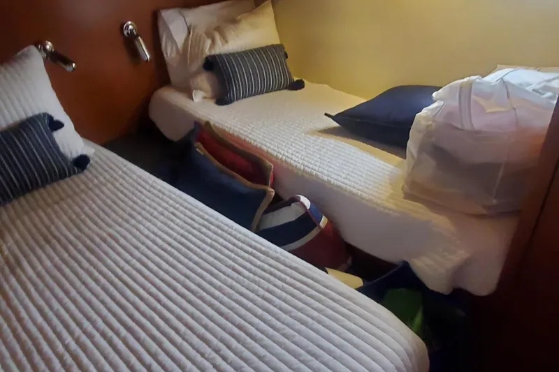 Slide: The Image of Cozy twin cabin in 2001 Tiara Yachts 52 Express Cruiser with striped bedding. - 18