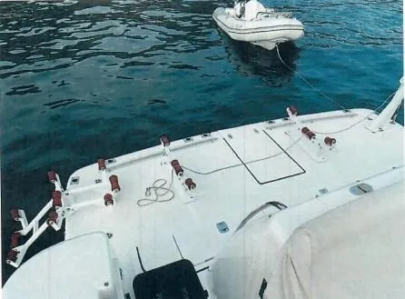 Slide: The Image of Tiara Yachts 2001 52 Express Cruiser with tender on calm water. - 25
