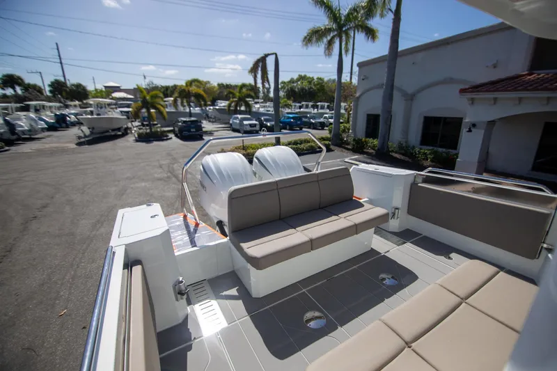 Slide: The Image of 2025 Quarken 35 Cabin boat interior with seating, parked outdoors under palm trees. - 15