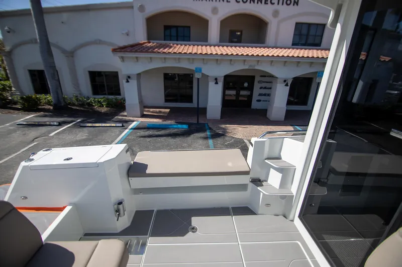 Slide: The Image of 2025 Quarken 35 Cabin boat interior with seating, docked near a building. - 22