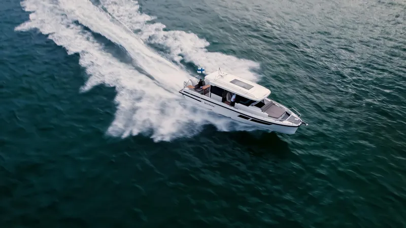 Slide: The Image of 2025 Quarken 35 Cabin boat cruising on open water, aerial view. - 5