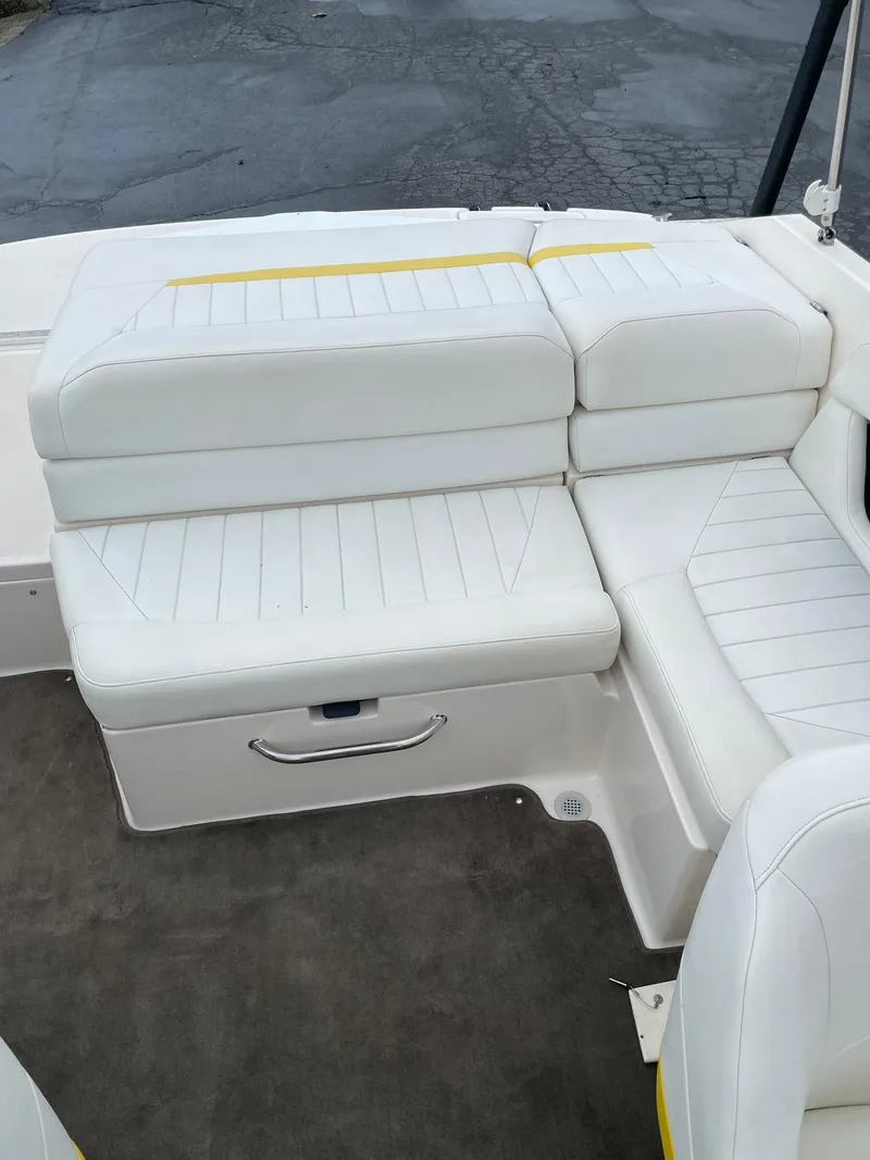 Slide: The Image of 2006 Regal 2000 Bowrider boat with white cushioned seating. - 12