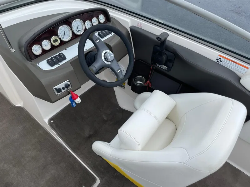 Slide: The Image of 2006 Regal 2000 Bowrider boat cockpit with steering wheel and gauges. - 17