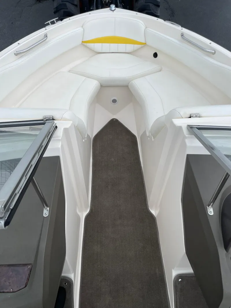 Slide: The Image of 2006 Regal 2000 Bowrider boat interior with white seating and carpeted floor. - 21