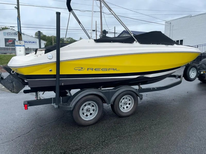 Slide: The Image of 2006 Regal 2000 Bowrider boat with yellow hull on a trailer. - 6