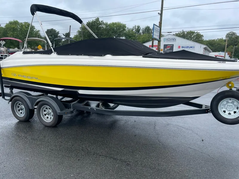 Slide: The Image of 2006 Regal 2000 Bowrider boat with yellow hull on a trailer. - 7