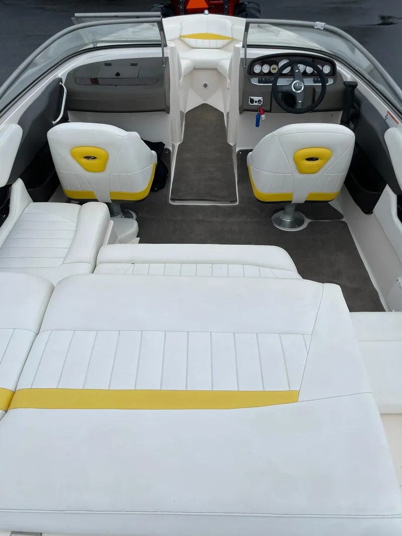 Slide: The Image of 2006 Regal 2000 Bowrider interior with white and yellow seating, steering wheel, and dashboard. - 8