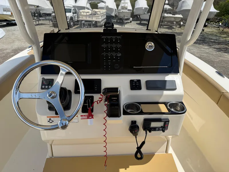 Slide: The Image of 2019 Scout 235 XSF boat dashboard with steering wheel and control panel. - 11