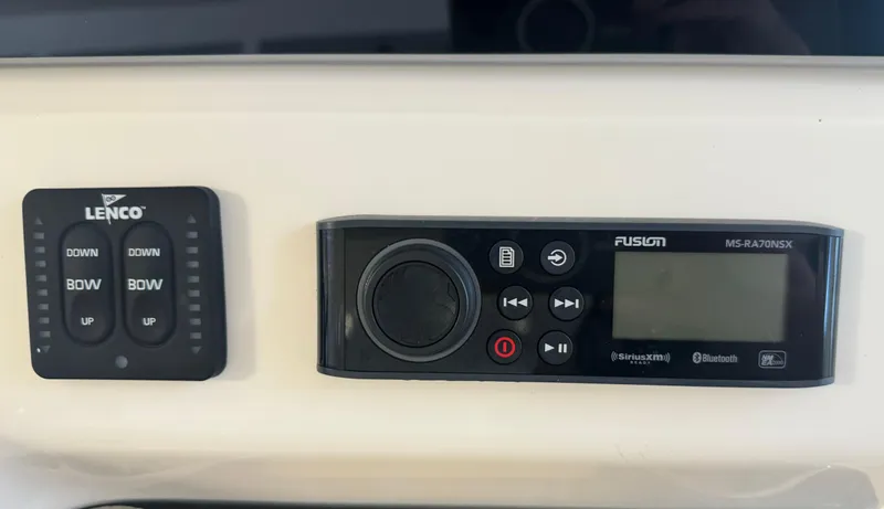 Slide: The Image of Control panel of a 2019 Scout 235 XSF boat with Lenco and Fusion systems. - 13